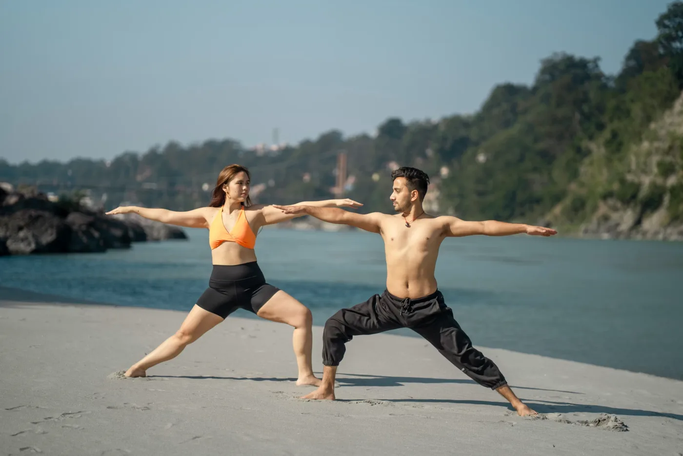 A couple holding the same pose, side by side.